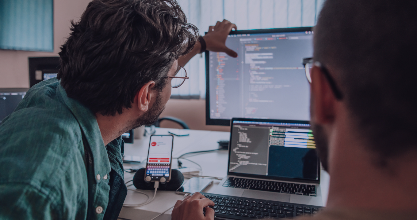 Developers collaborating and reviewing code together in a software project meeting